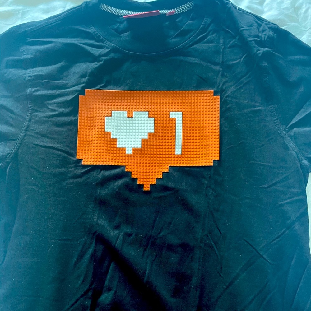 Mostly Heard Rarely Seen Black Tee with Orange and White Graphic
